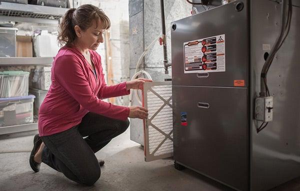 Woman replacing air filter